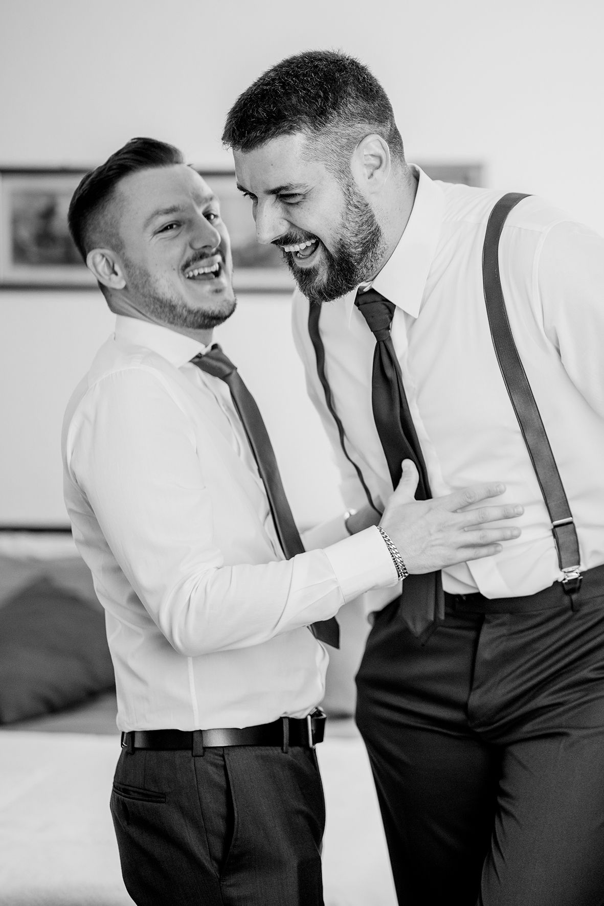 Two people in formal attire share joyful moments in a black and white photo series.