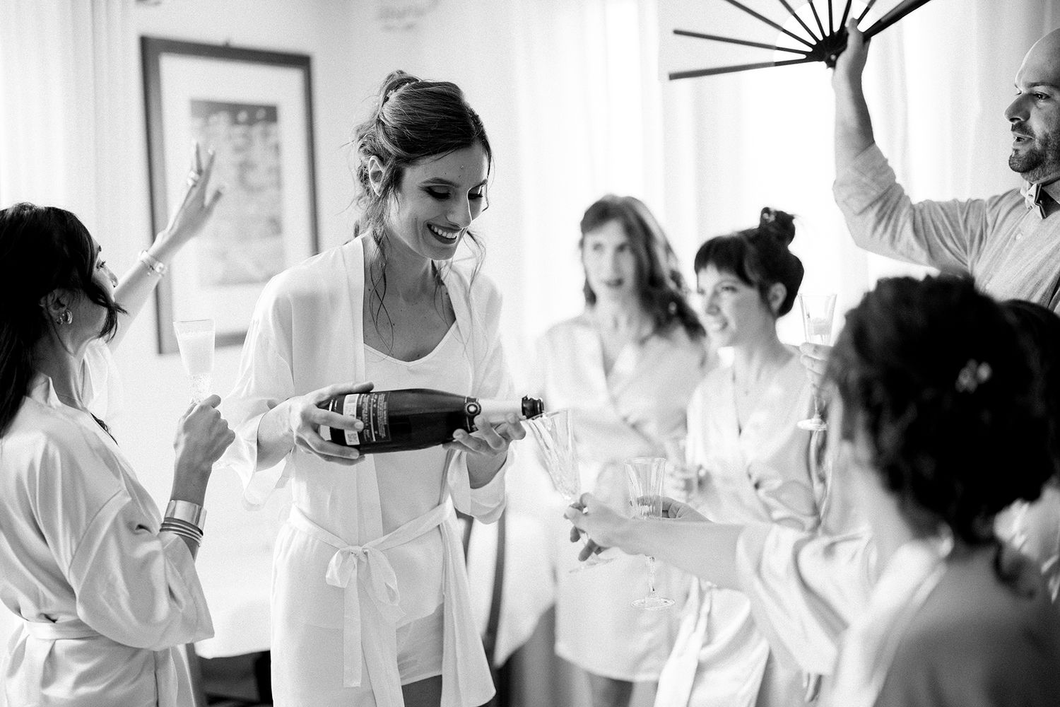 Candid black and white photos of wedding morning preparations with bridesmaids.