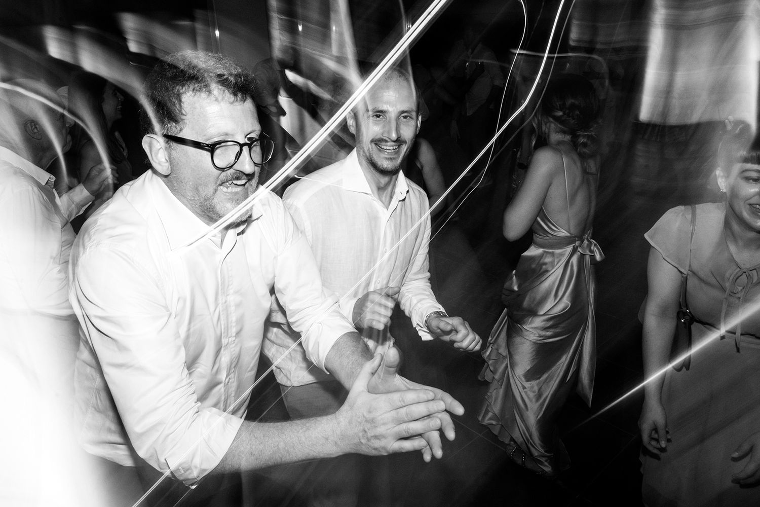 Energetic black and white party photos showing people dancing and having fun.