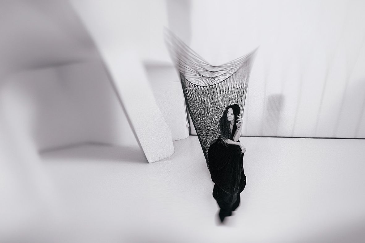 Artistic black and white portrait series showing movement and ethereal poses against a light background.