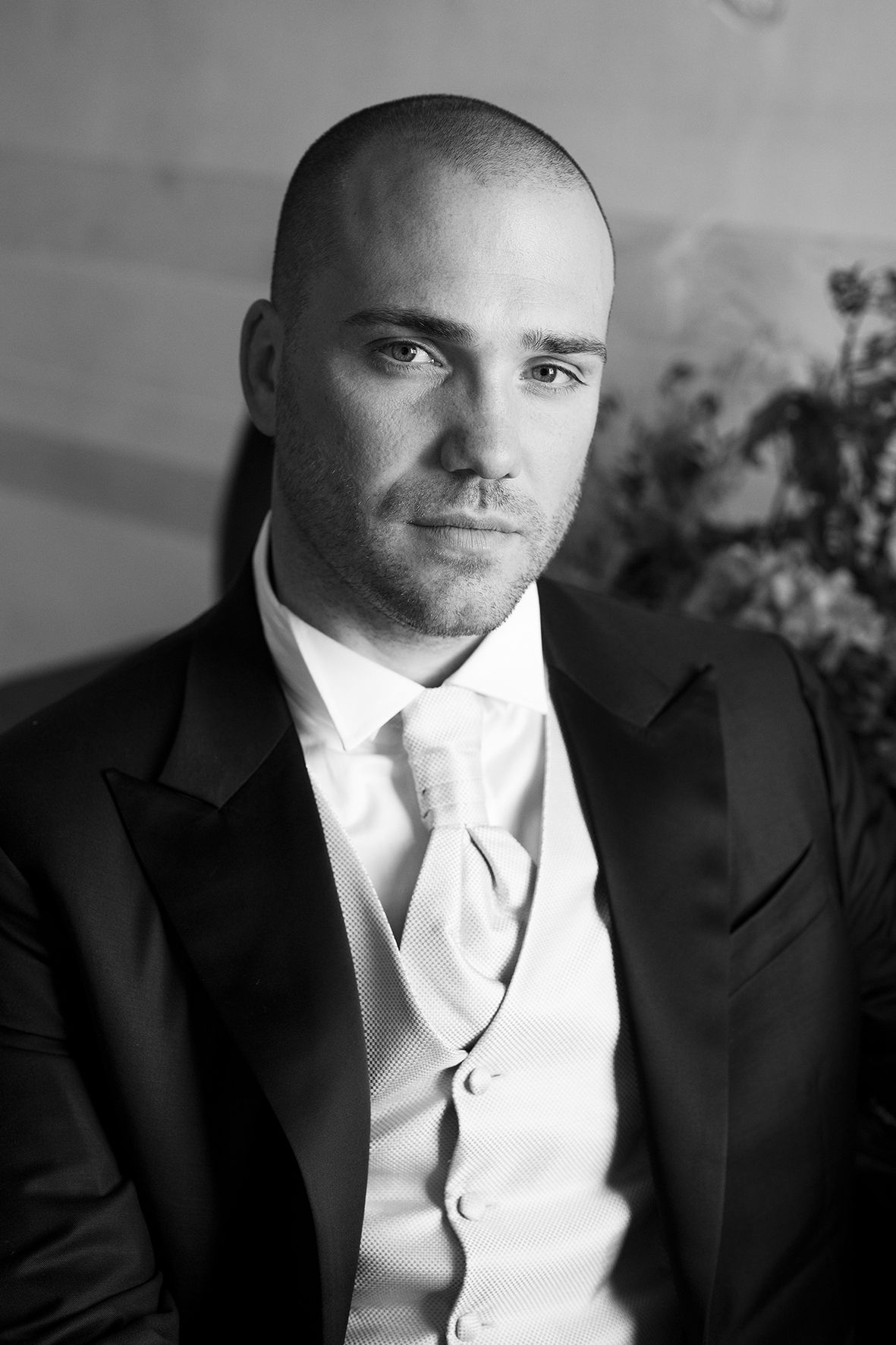 Classic black and white portrait of groom in formal tuxedo and tie.