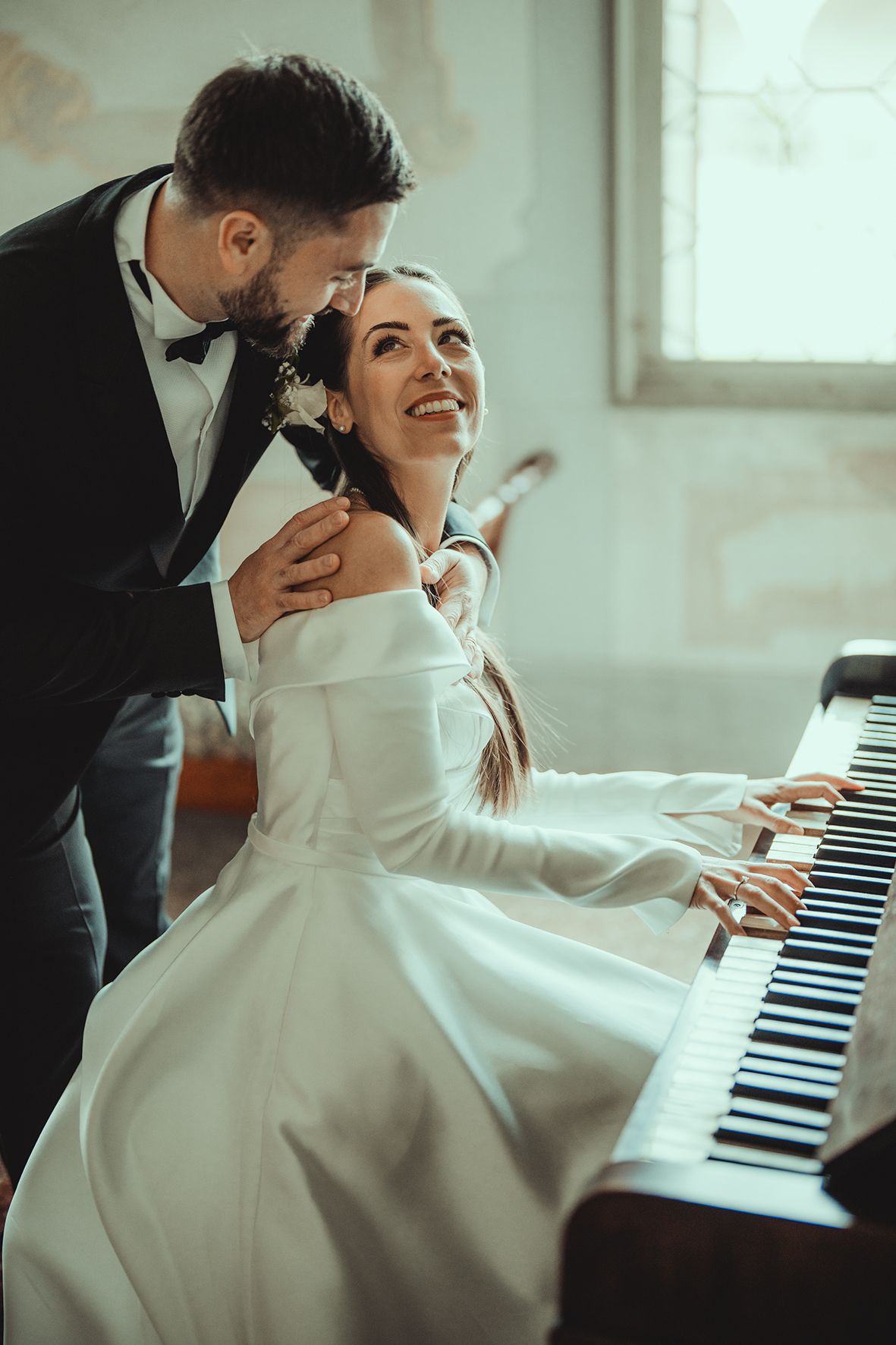 Candid shots of newlyweds sharing intimate moments while seated at a piano.