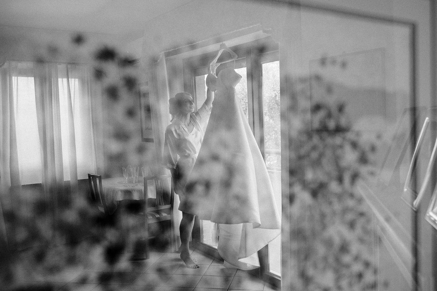 Ethereal black and white photos showing silhouettes through sheer curtains.