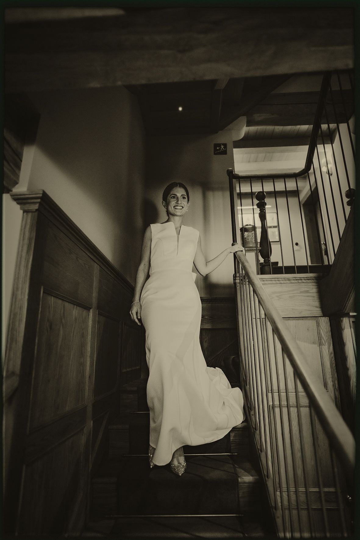 A haunting sequence of black and white photos showing a figure in white descending a dark staircase.