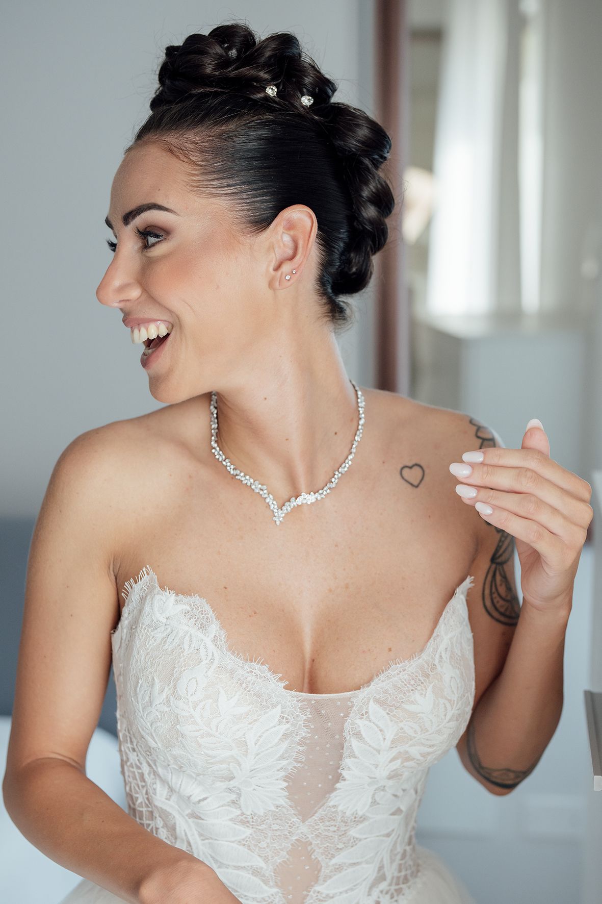 Close-up shots of a bride wearing an elegant white lace wedding dress and crystal necklace.