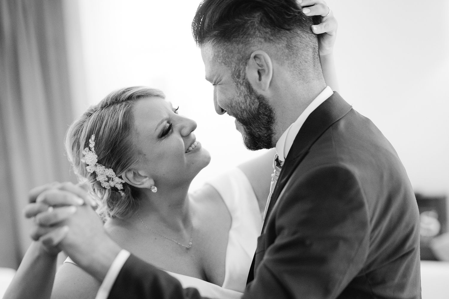 Black and white wedding photos capturing tender moments between a couple.