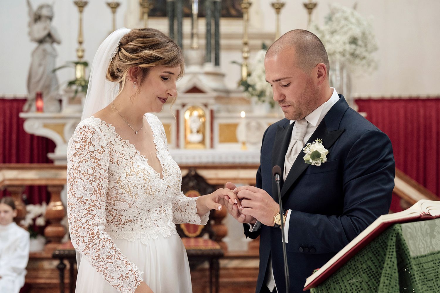 Couple shares heartfelt reactions during their wedding ceremony in a traditional church.