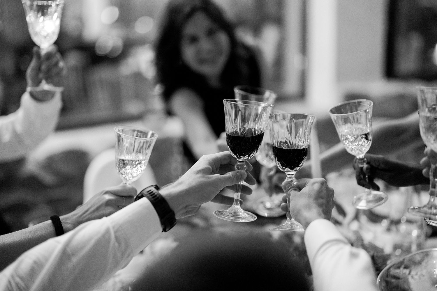 Wedding reception table settings with crystal glasses and elegant place settings in black and white.
