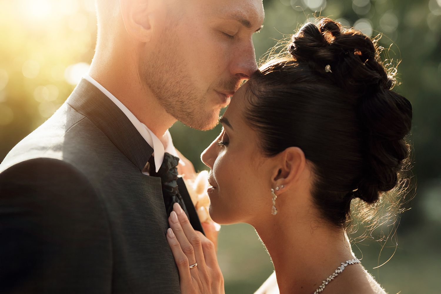 Golden hour wedding portraits with soft natural backlighting creating romantic atmosphere.
