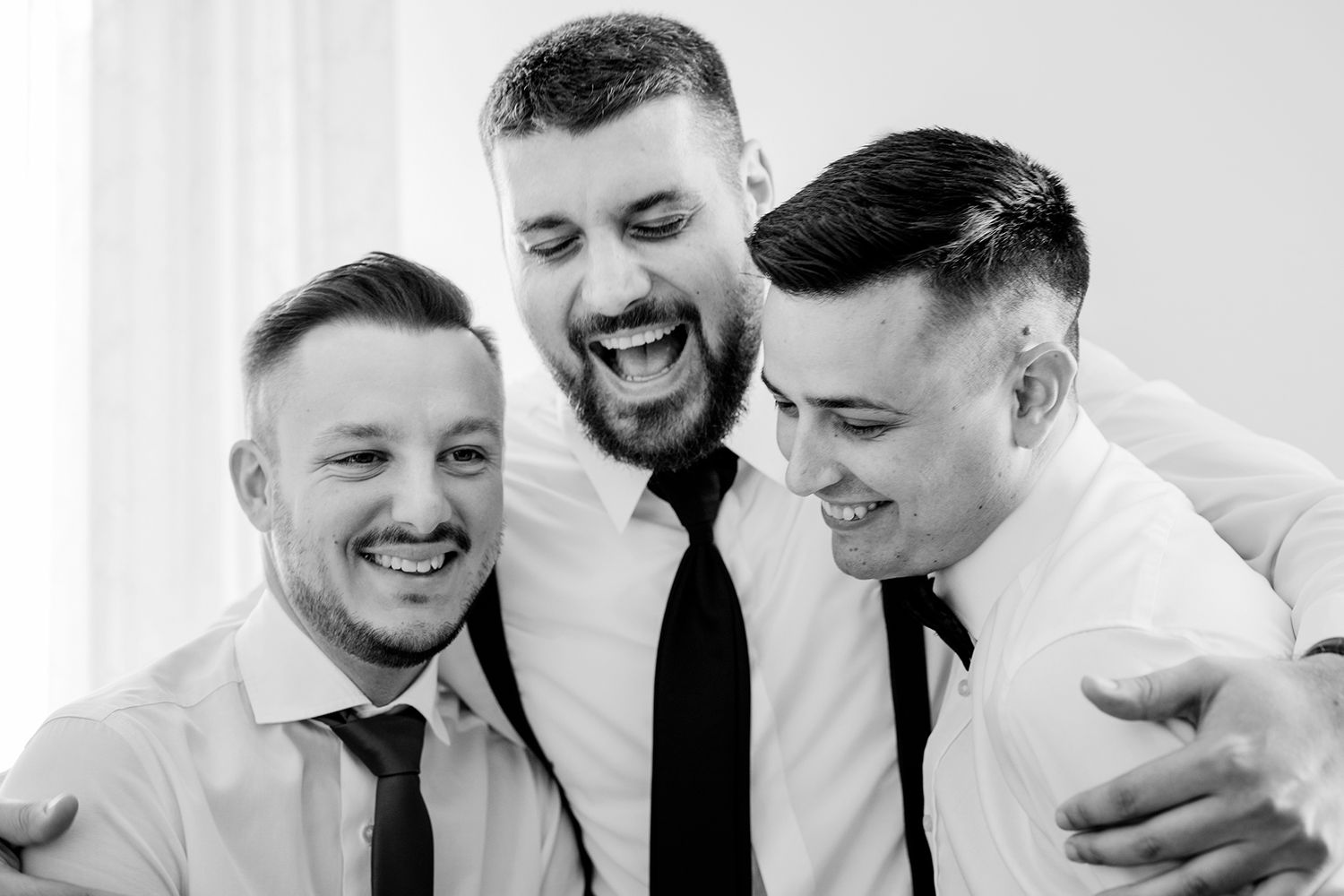 Black and white candid shots showing joyful moments in formal attire.
