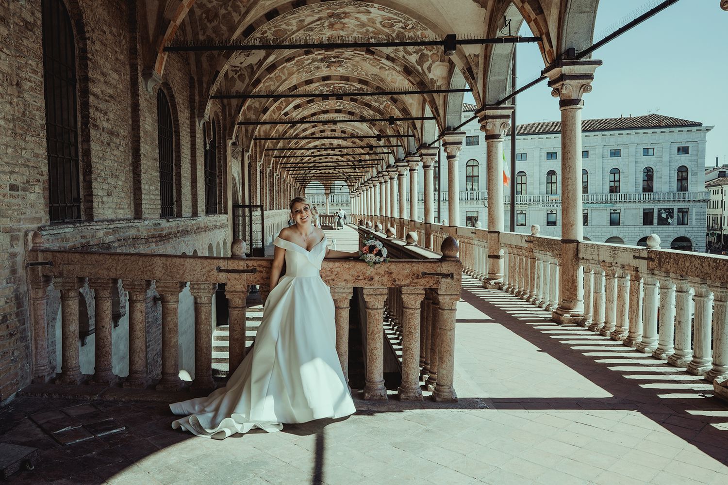 Wedding photography session in a beautiful colonnade with arched architecture.