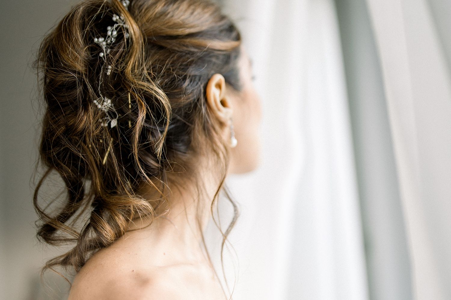 Close-up details of elegant bridal hairstyle with soft romantic styling.