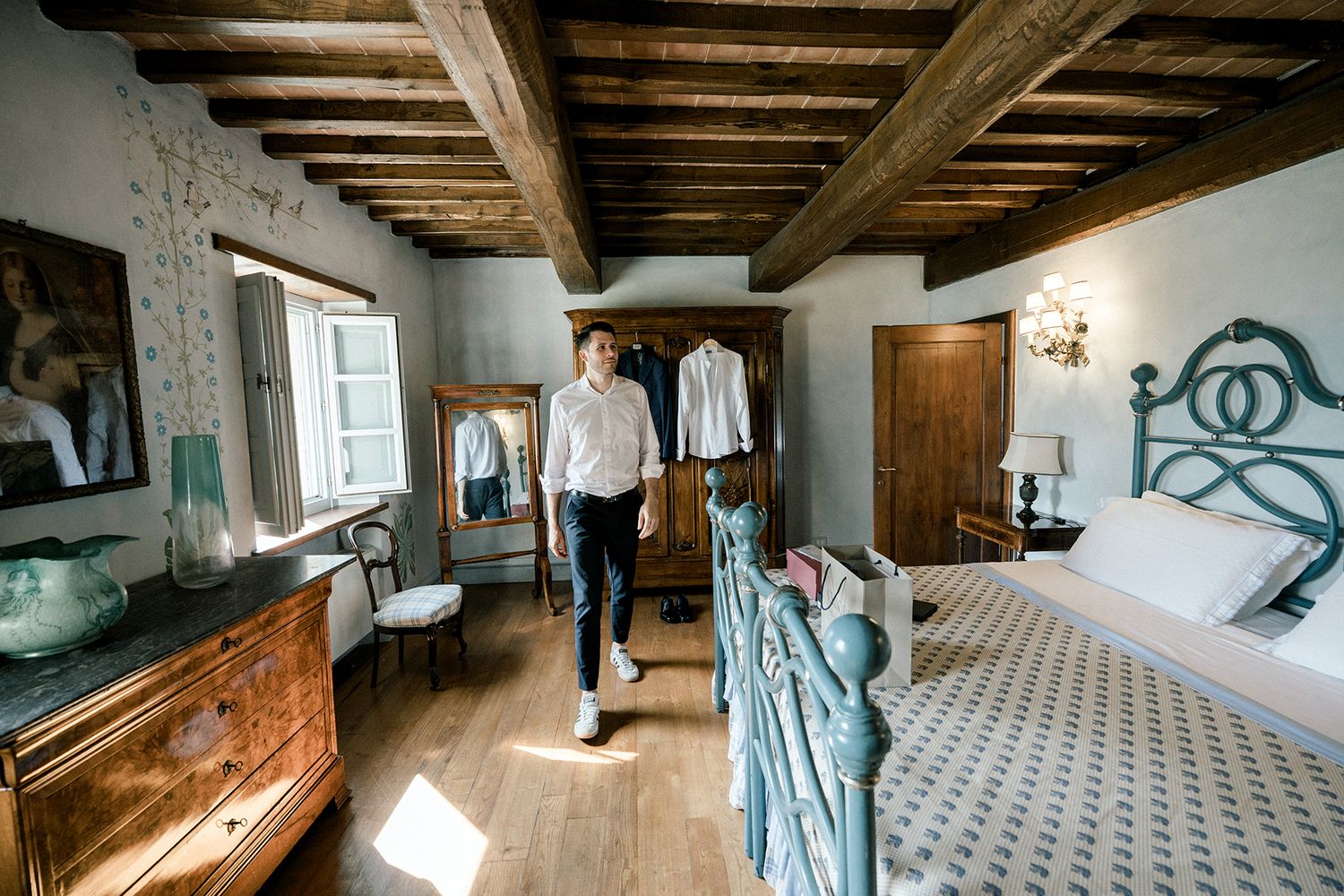 Rustic interior with exposed wooden beams and patterned tile flooring.