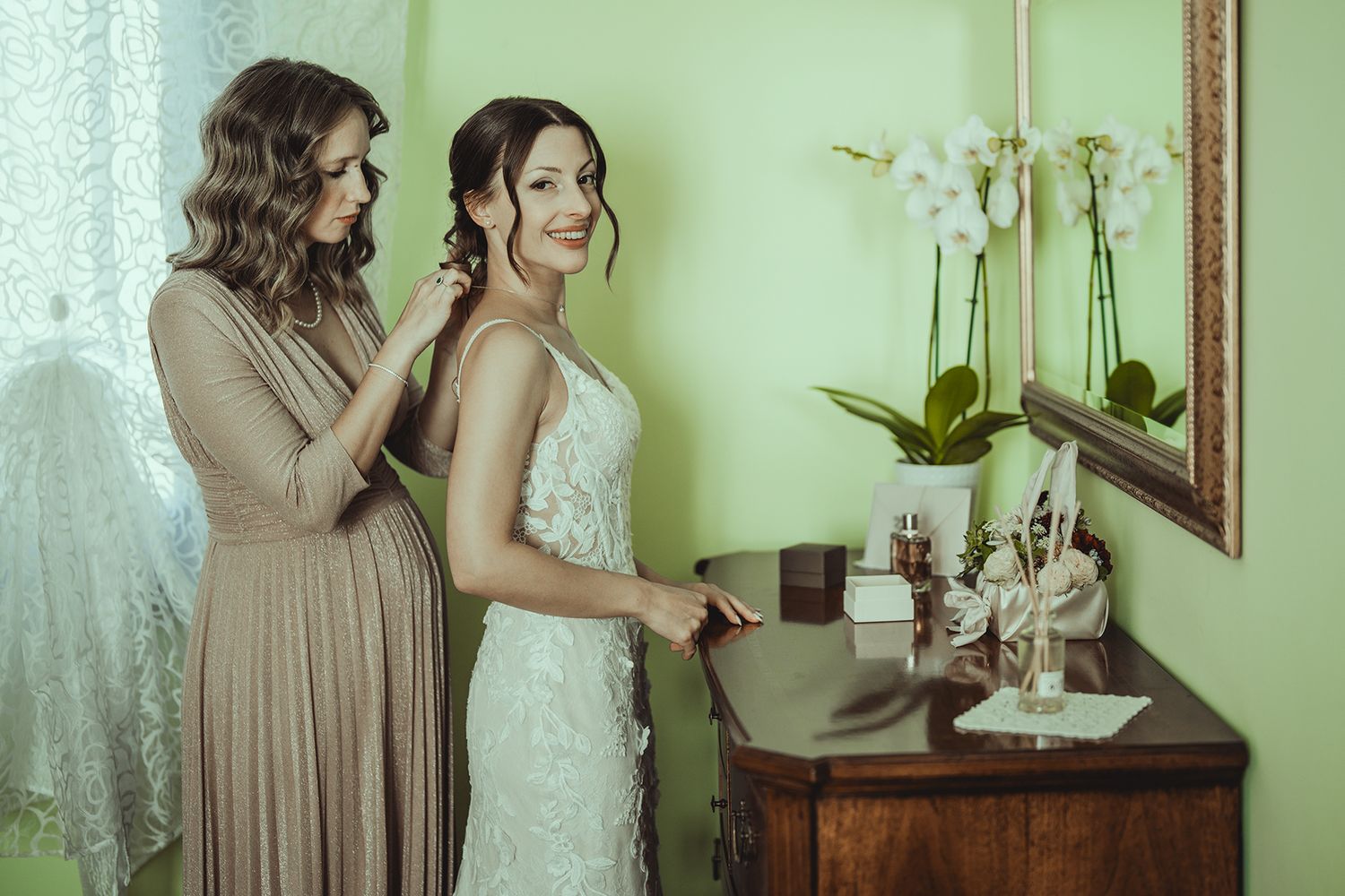 Wedding preparation scene with elegant decor and orchids in soft natural light.