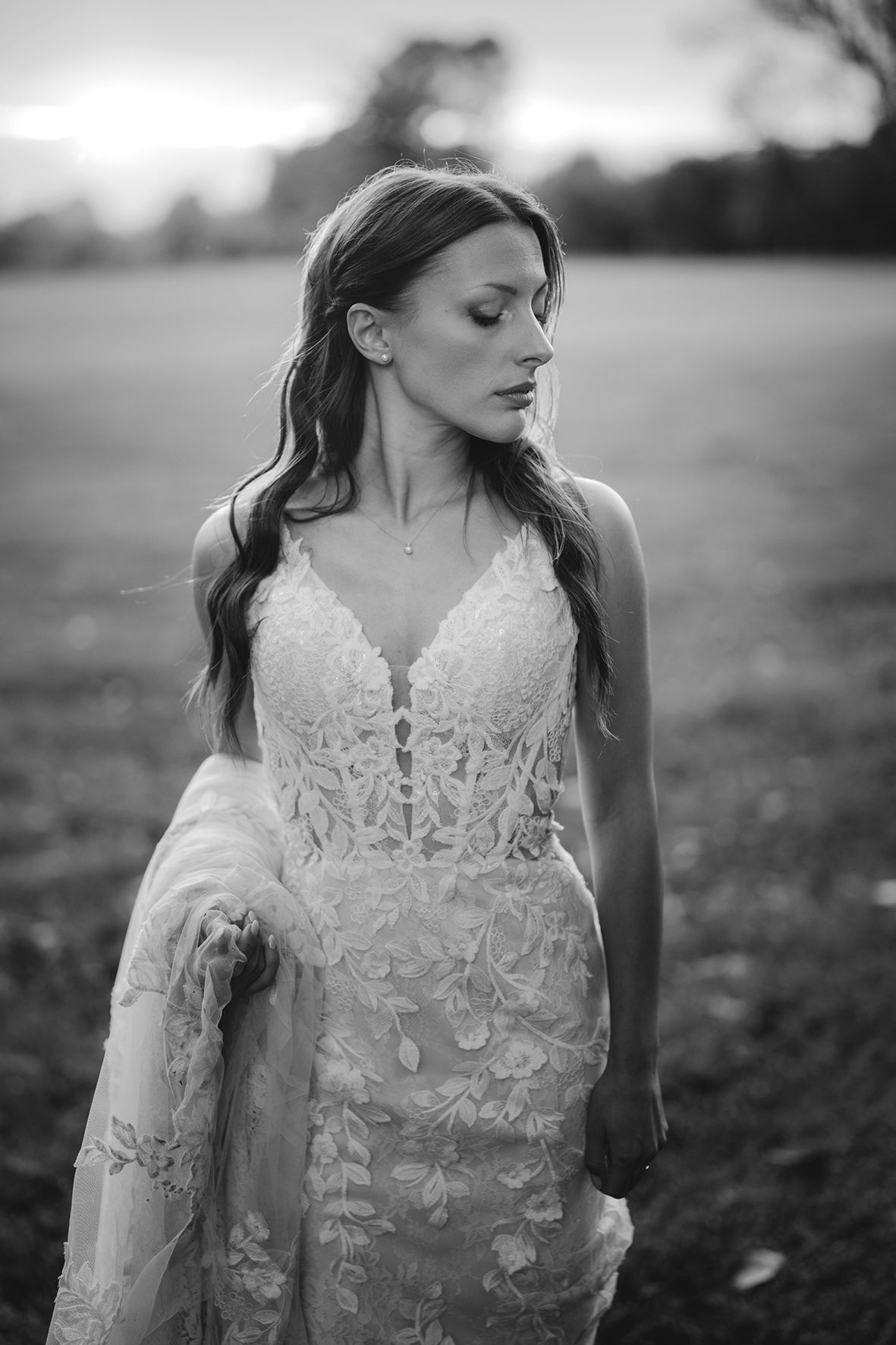 Close-up details of an intricate lace wedding dress with delicate floral patterns.