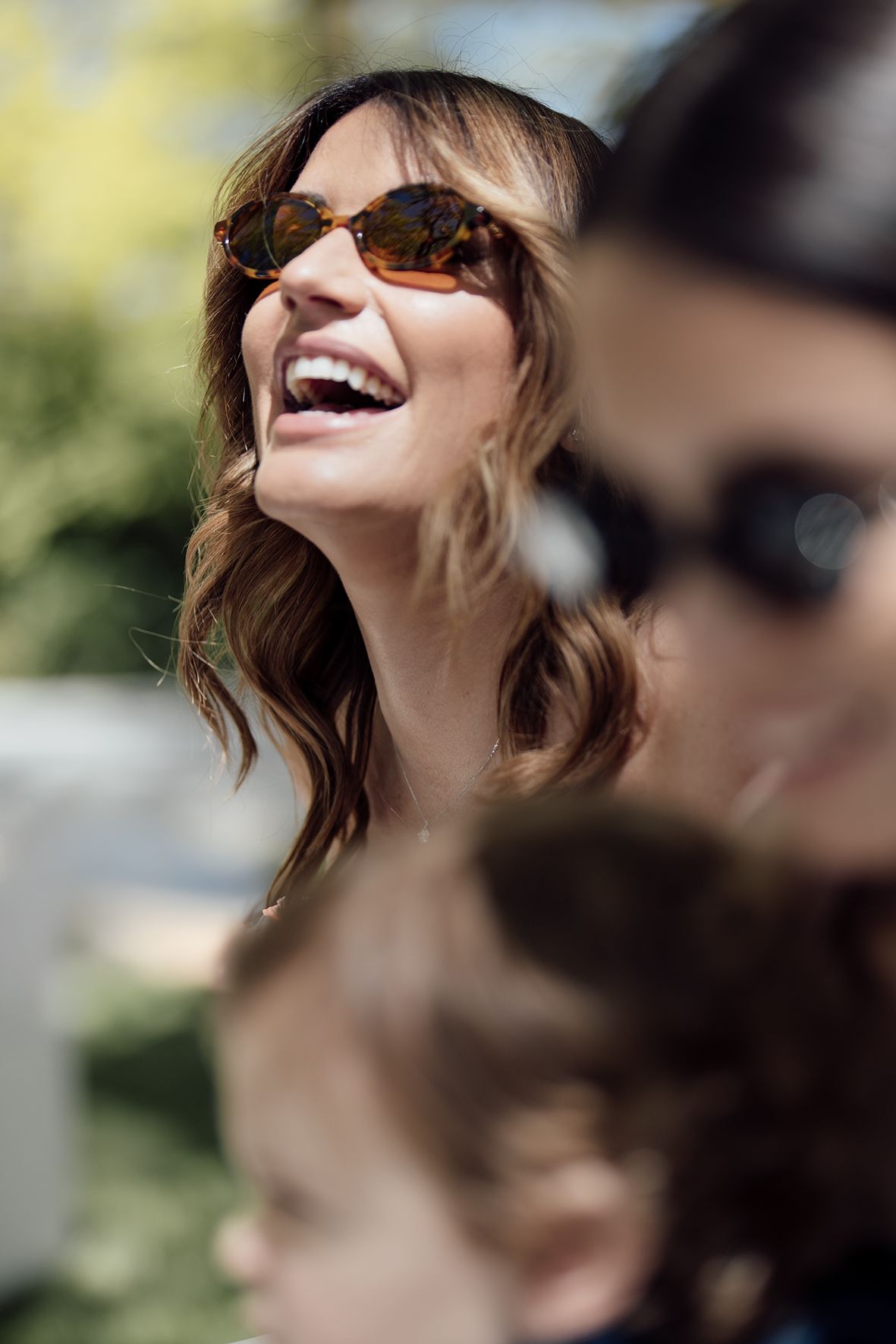 Close-up shots of people wearing sunglasses at an outdoor celebration.
