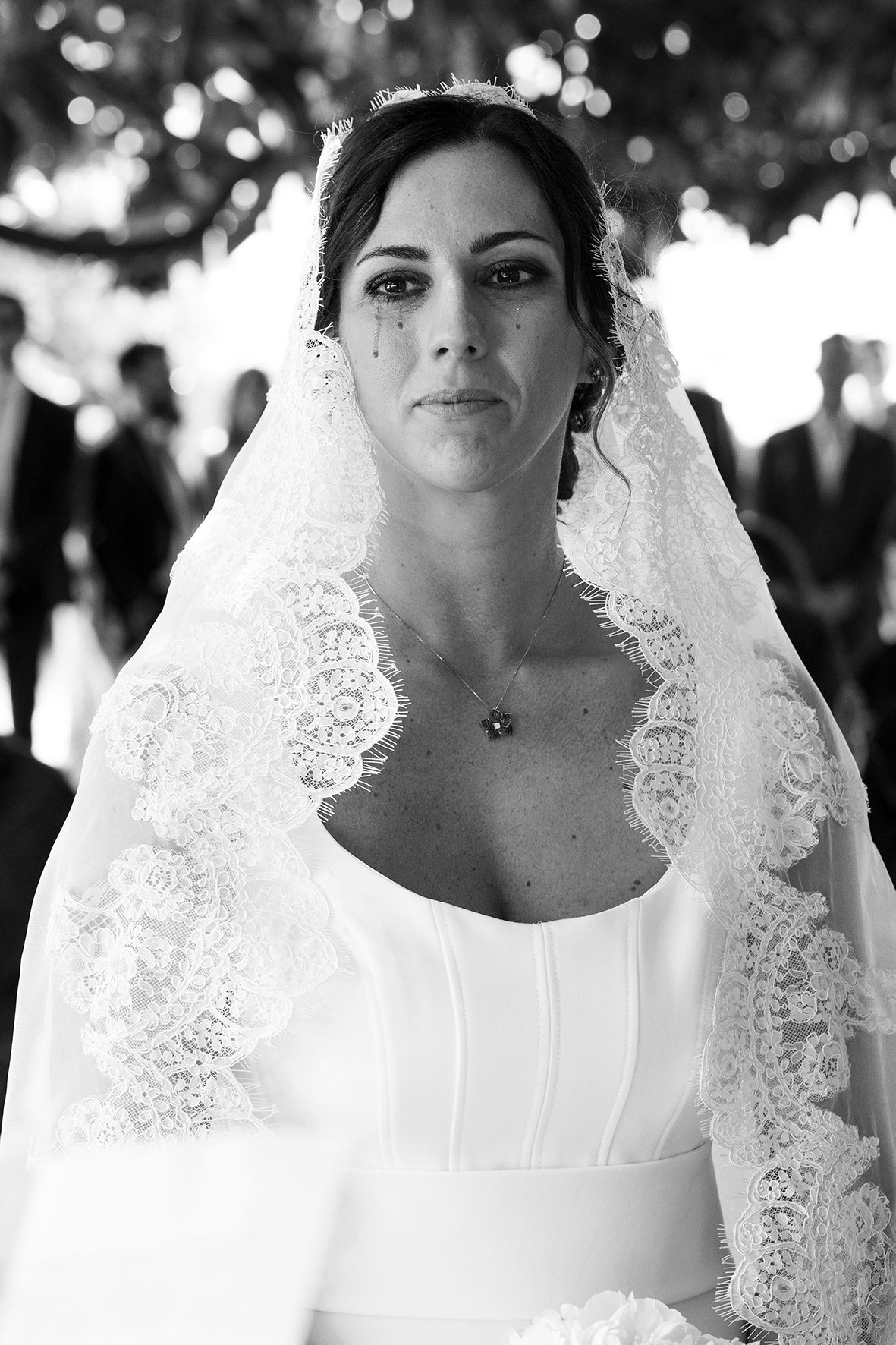Close-up portraits of a bride wearing a white lace veil and wedding dress.