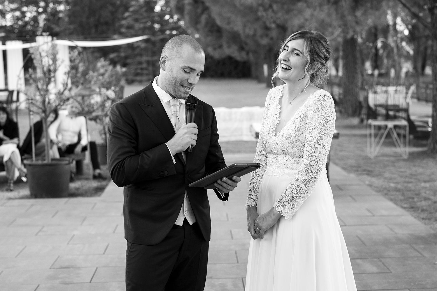 Candid black and white wedding portraits showing laughter and joy.