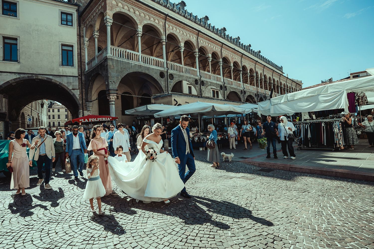 Wedding celebration in a historic courtyard with cobblestone pavement.