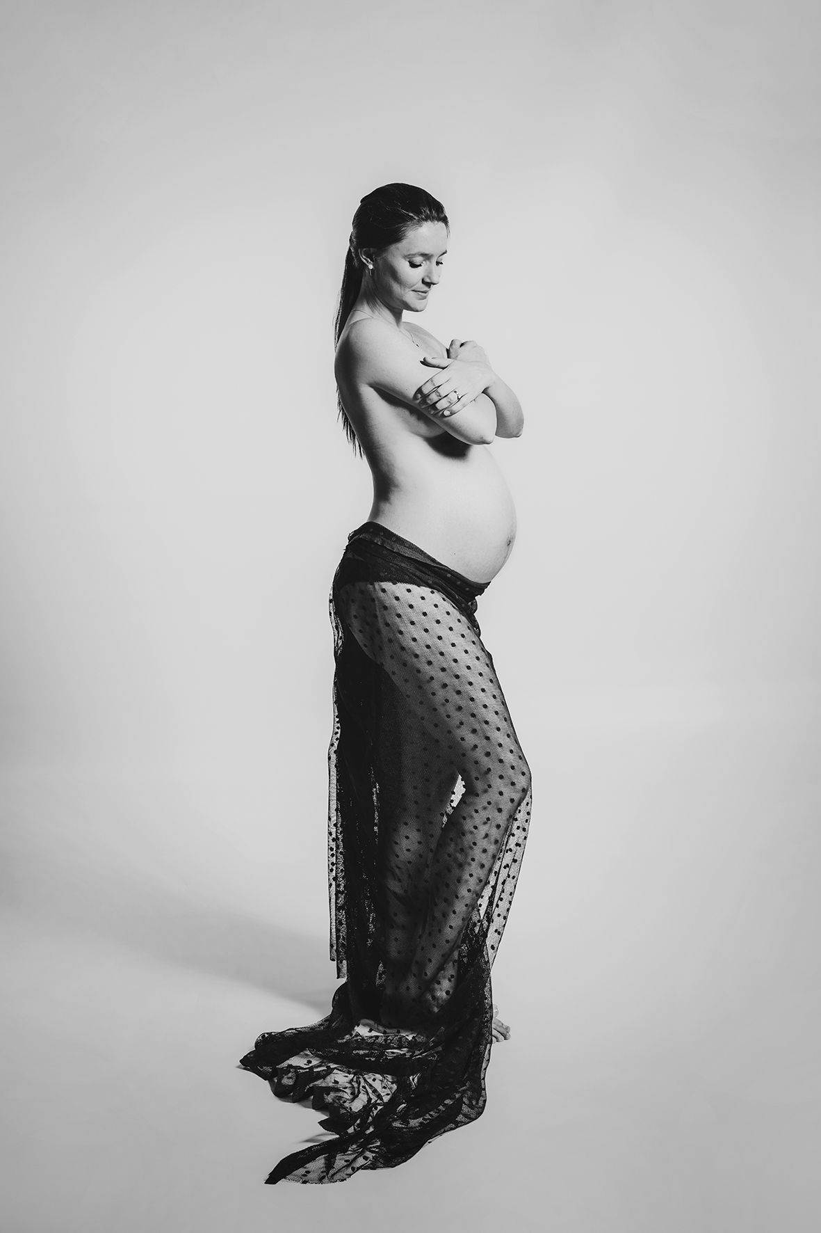 Artistic black and white portrait featuring draped lace fabric.