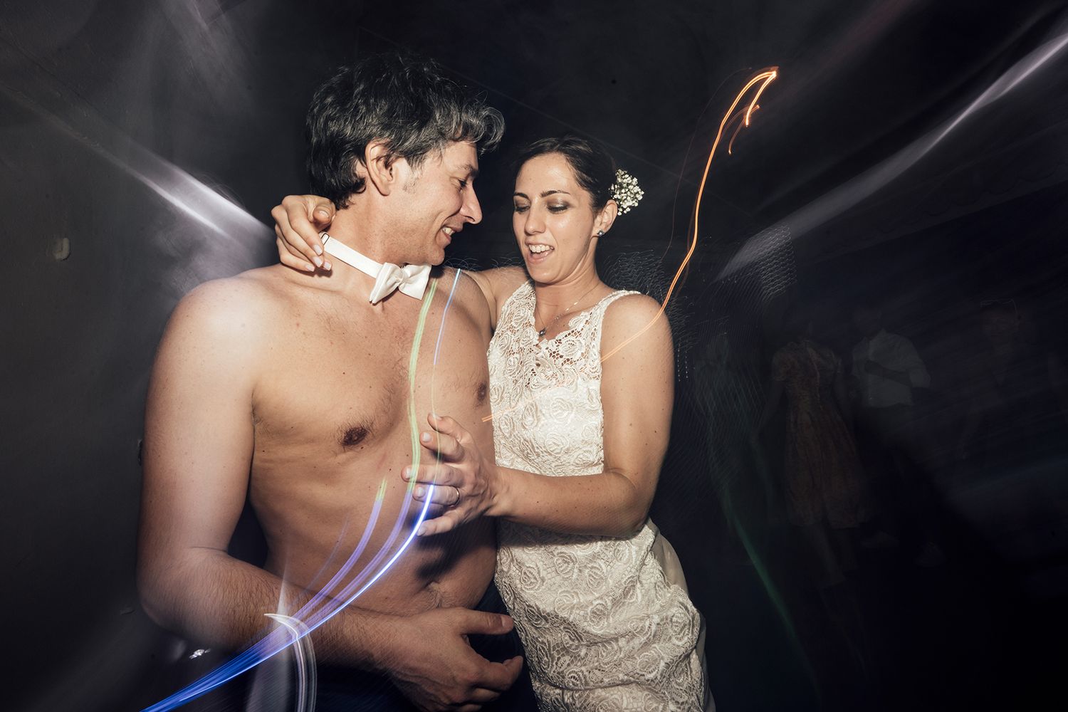Dramatic dance moves captured at a wedding reception with dynamic lighting effects.