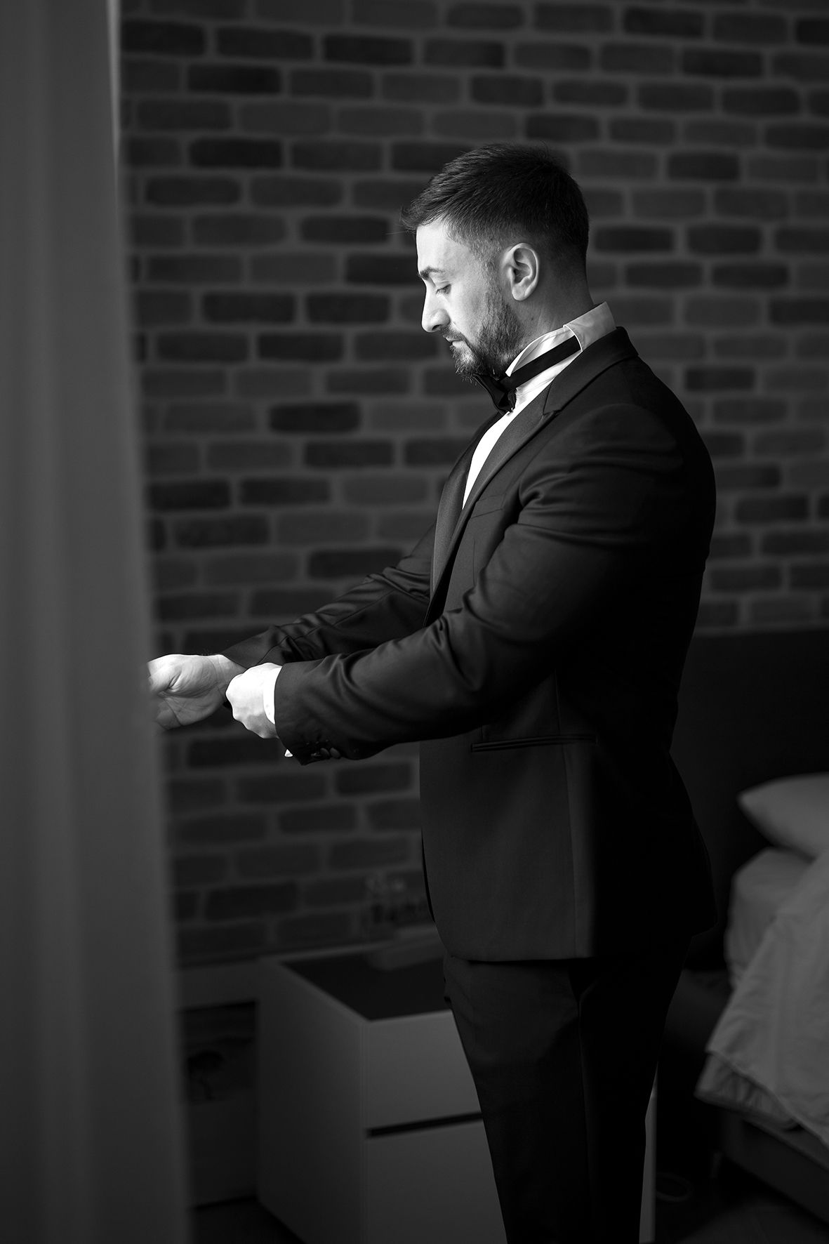 Series of silhouettes against brick wall showing figure in formal attire making expressive gestures.