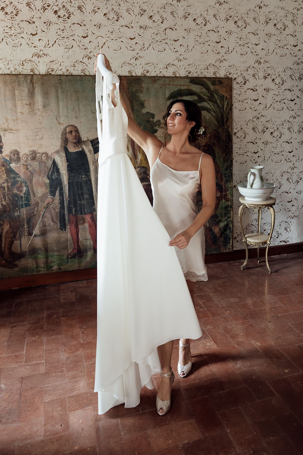 A series of images showing a white dress being prepared in a room with terracotta floors and vintage decor.