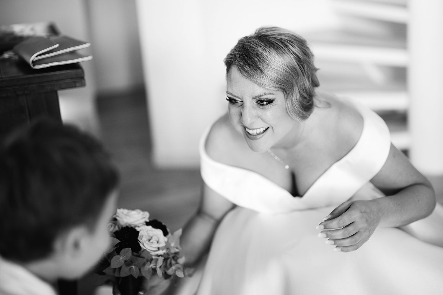 Black and white candid moment during wedding preparations.