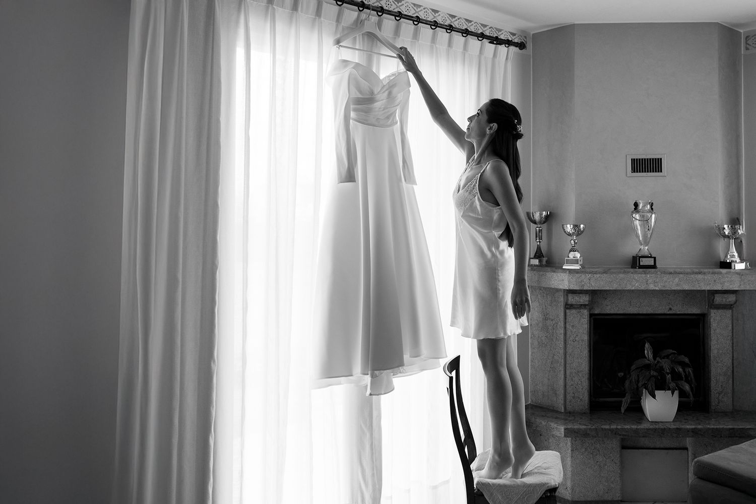 Sunlit room with white curtains and elegant interior decor.