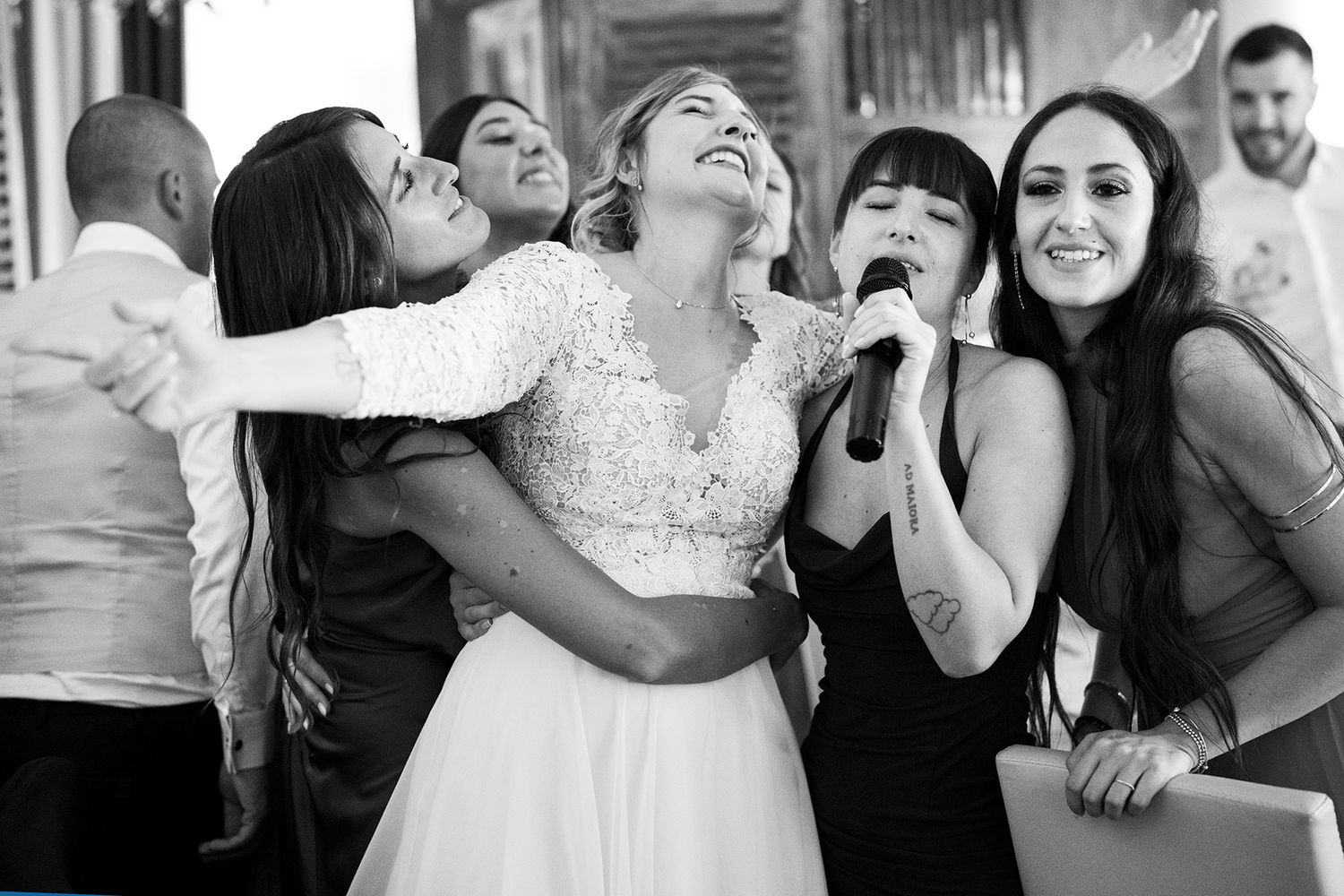 Wedding reception candid moments showing guests dancing and laughing together.