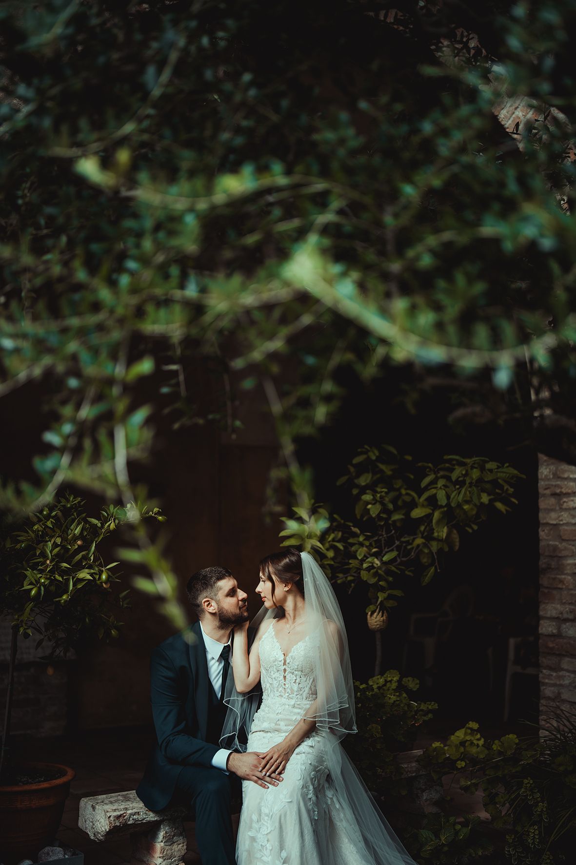 Romantic garden wedding photo with lush greenery and natural lighting.