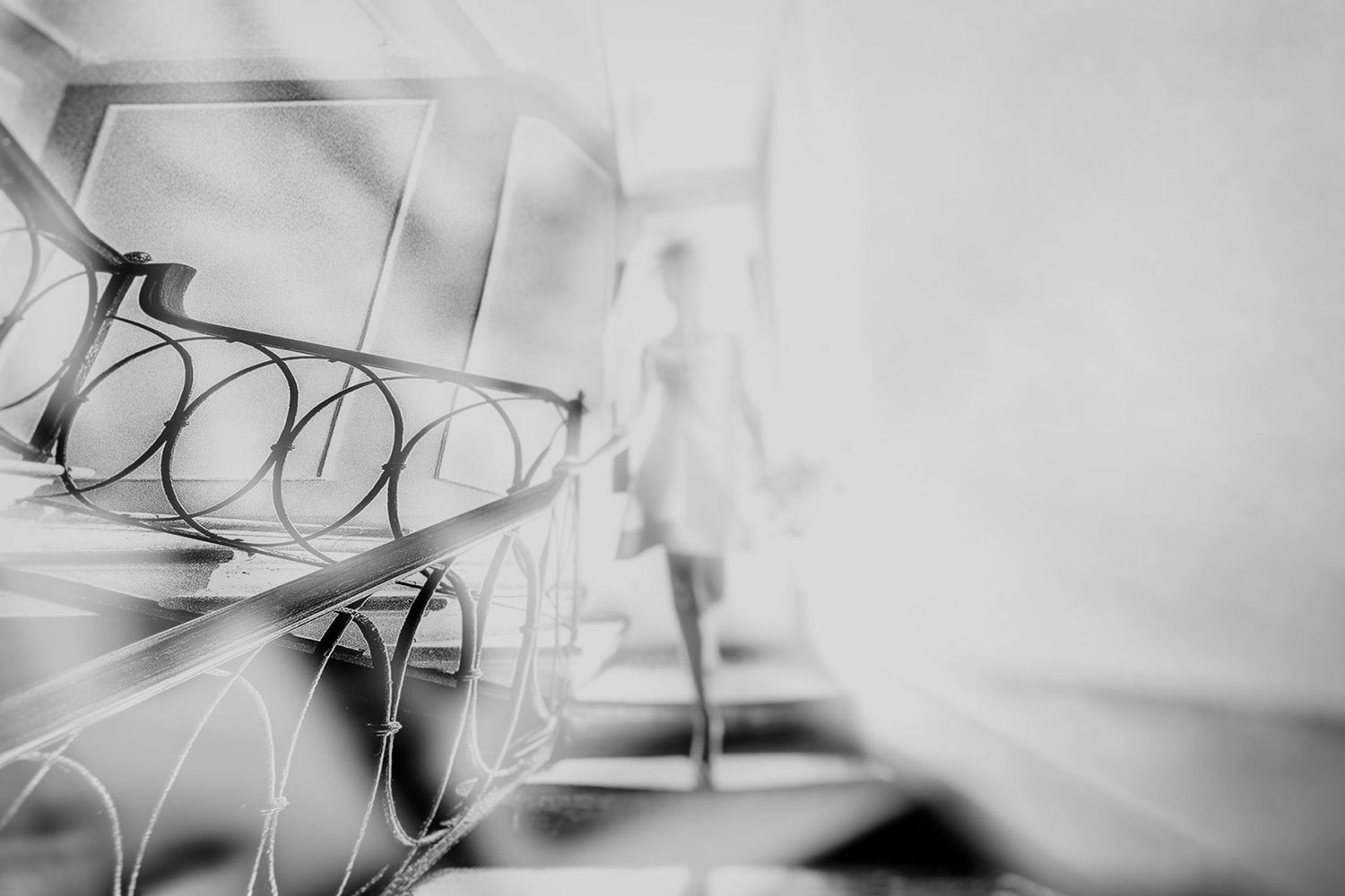Abstract black and white photograph showing blurred motion and light trails creating an ethereal pattern.