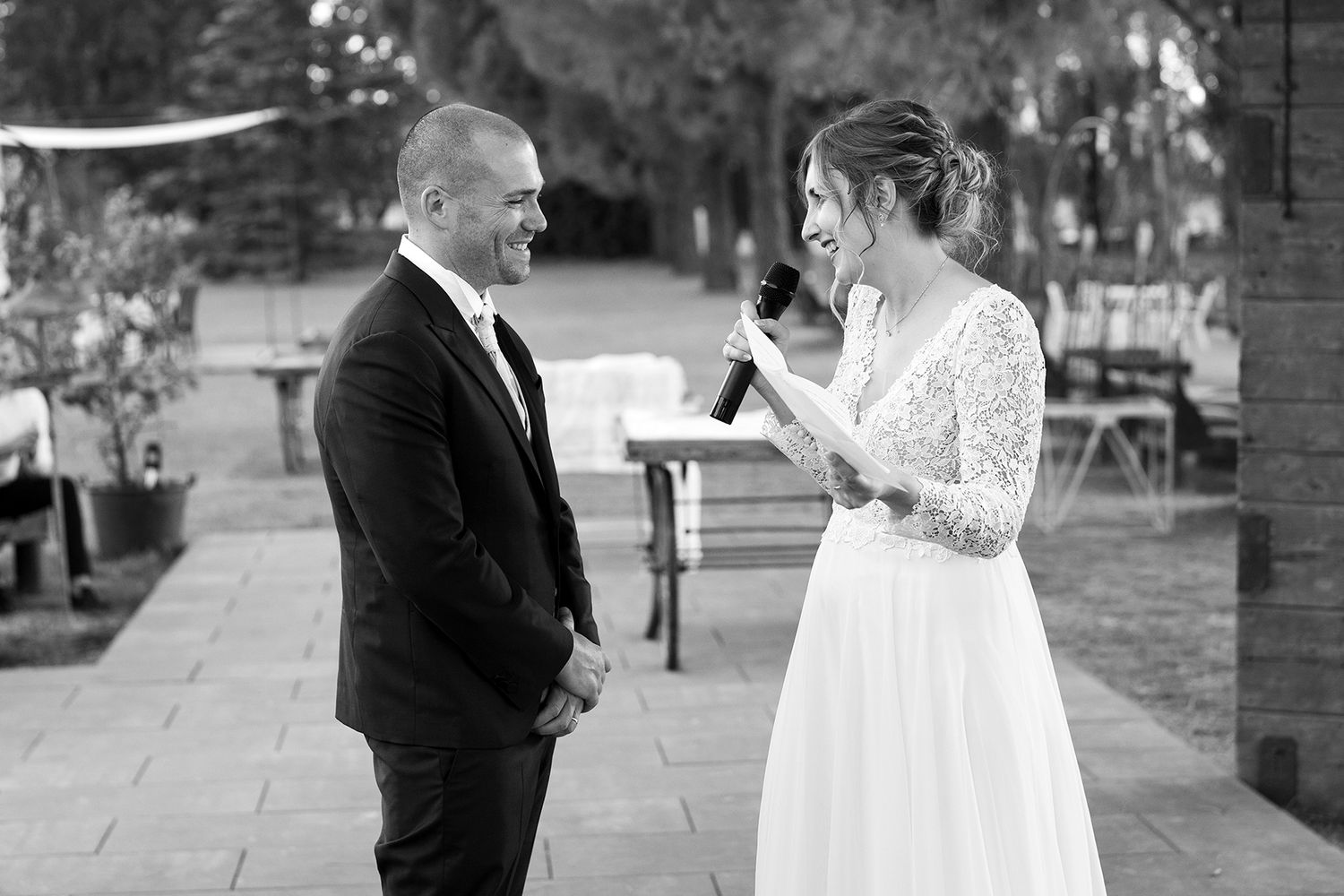Black and white wedding portraits capturing candid moments outdoors.