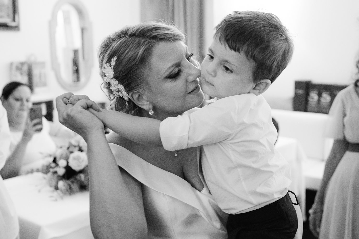 A series of tender black and white wedding kisses captured in an artistic sequence.
