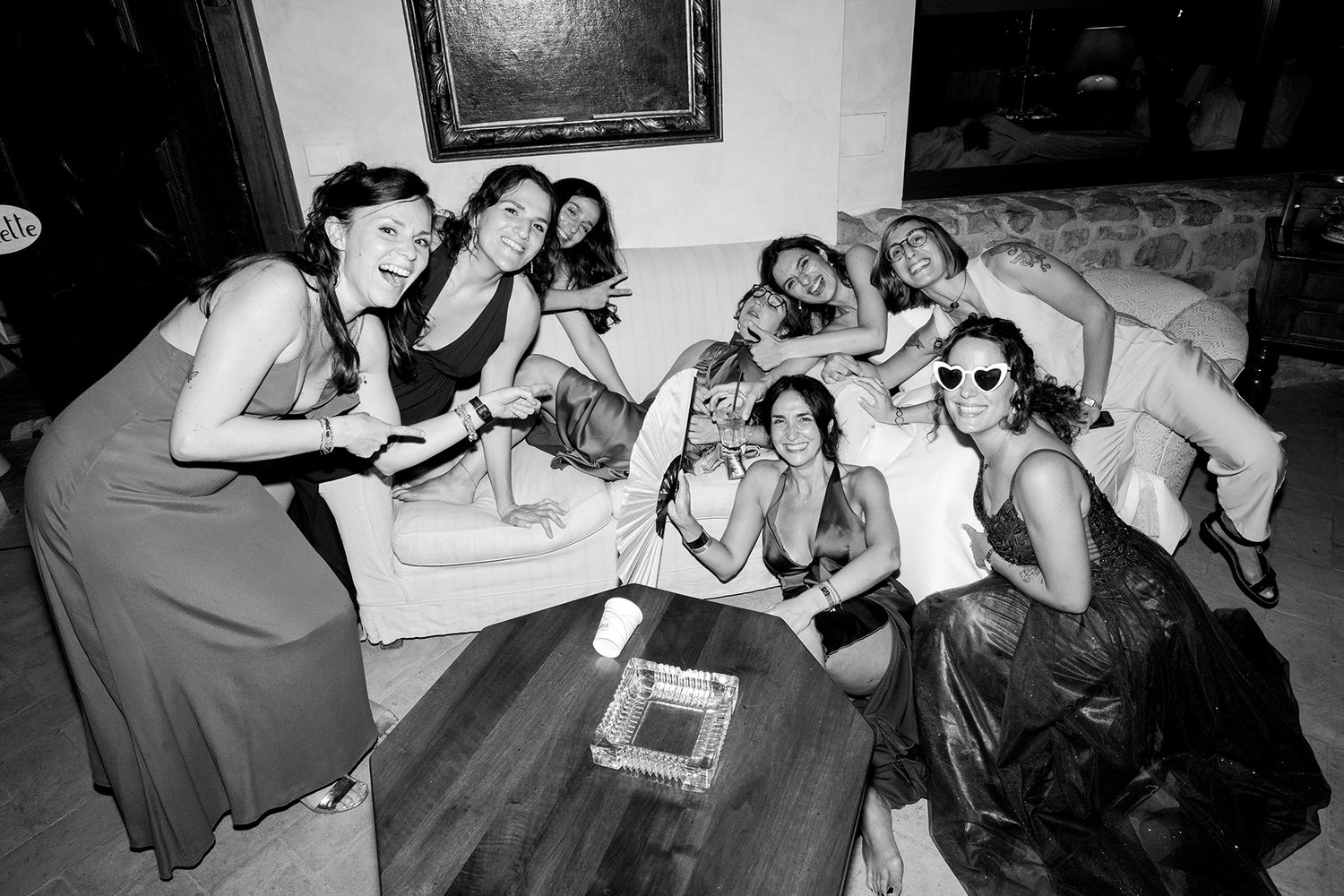 Wedding guests relaxing and socializing in casual black and white photos.