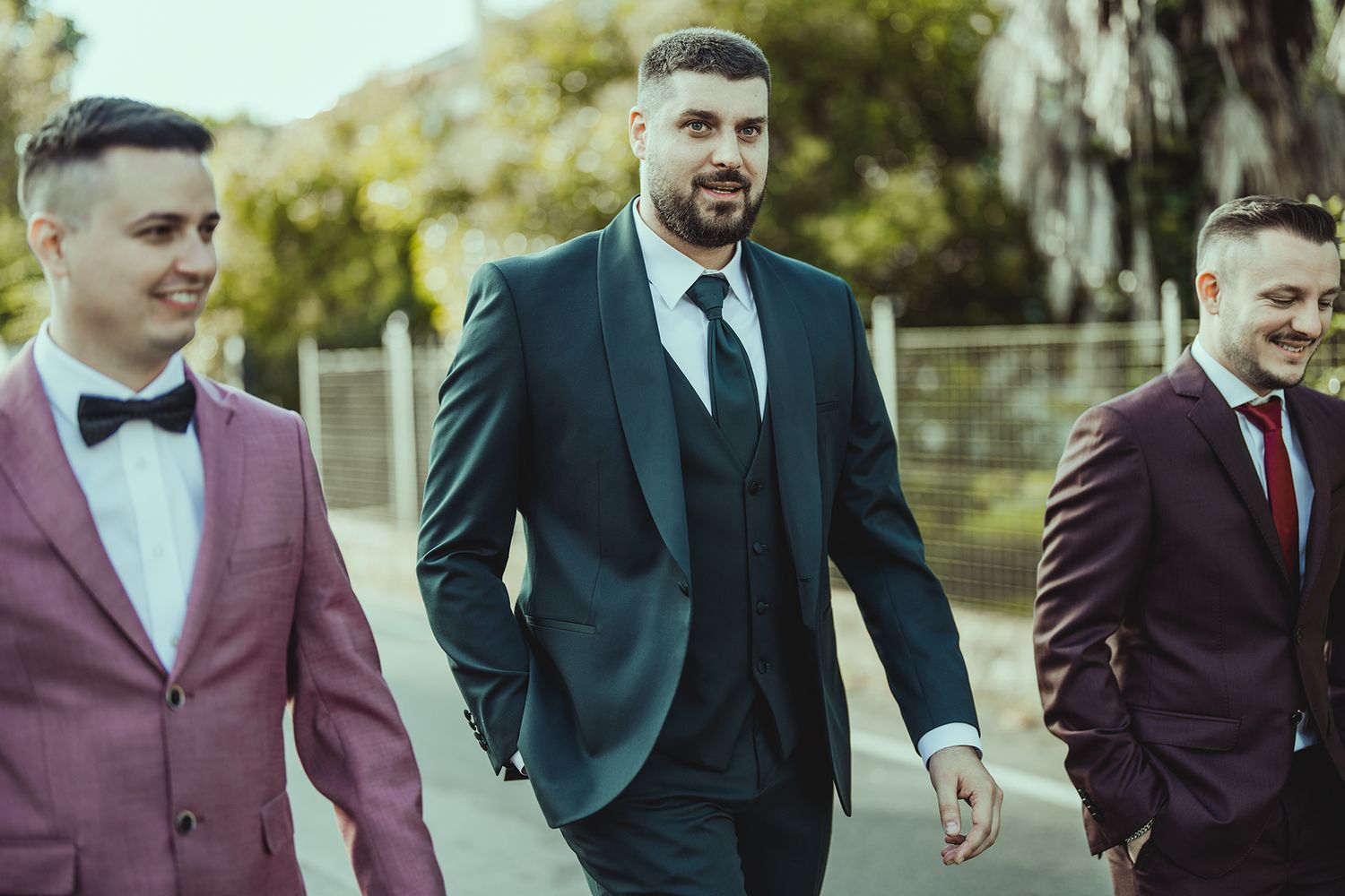 A group walks together outdoors wearing coordinated formal attire.