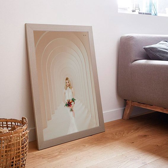 A series of photos showing a gray painted arch design on a white wall next to a woven basket and bed.