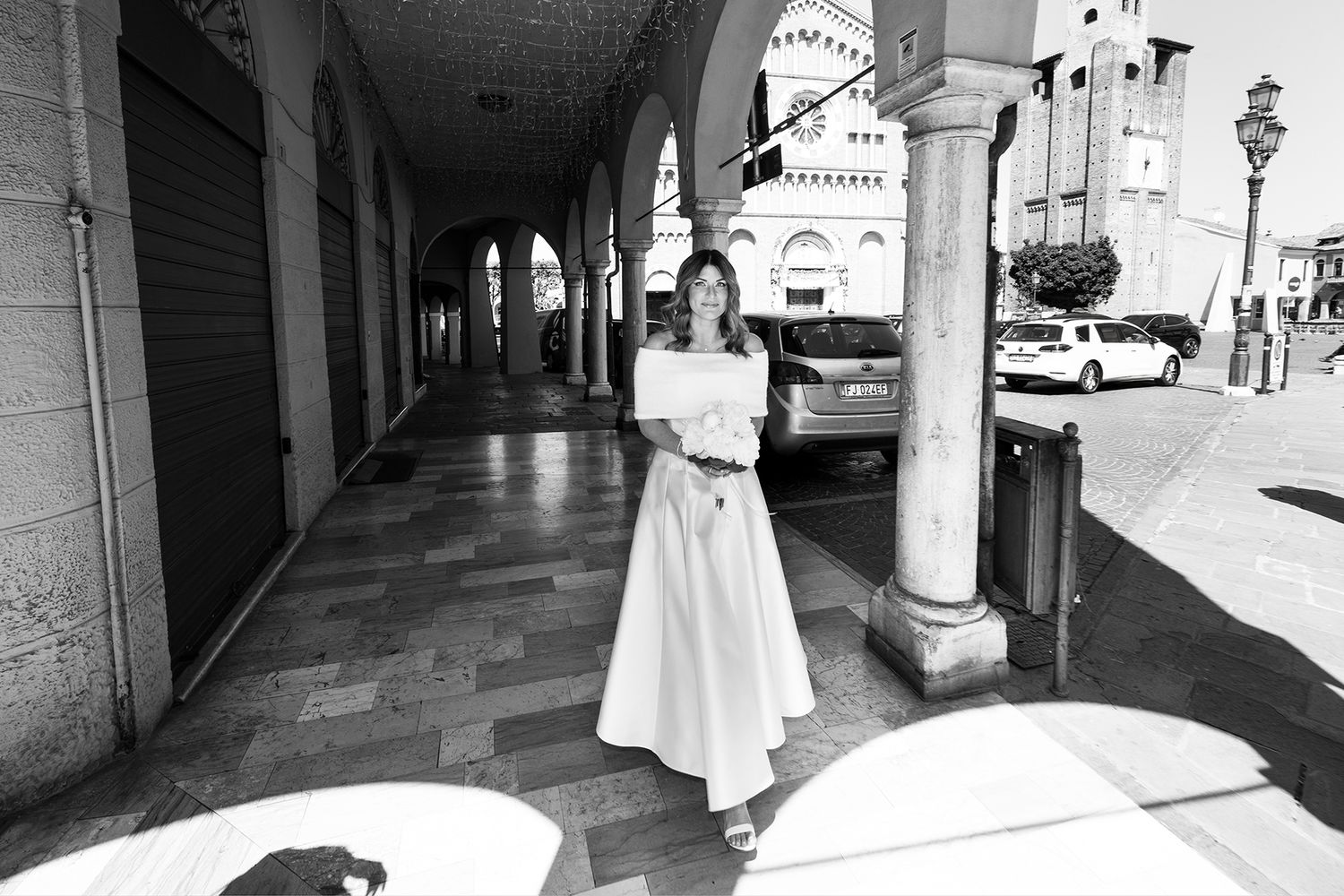 Black and white architectural shot of covered walkway with columns.