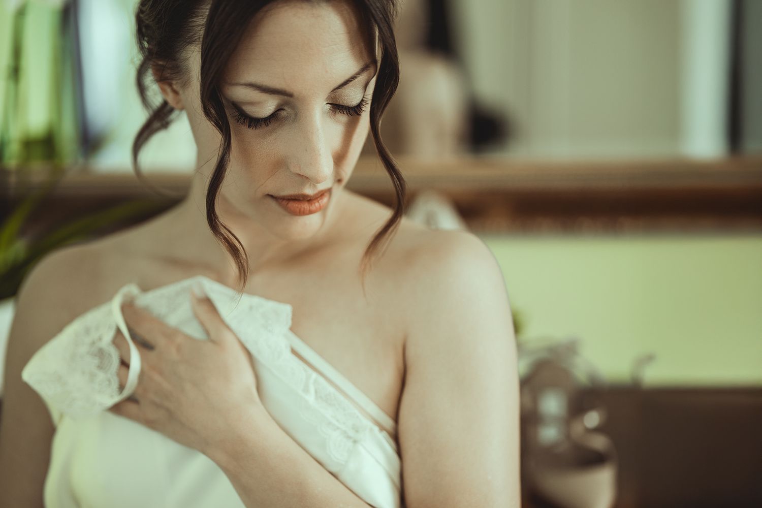 Close-up portrait in soft natural light showing delicate details of bridal attire.