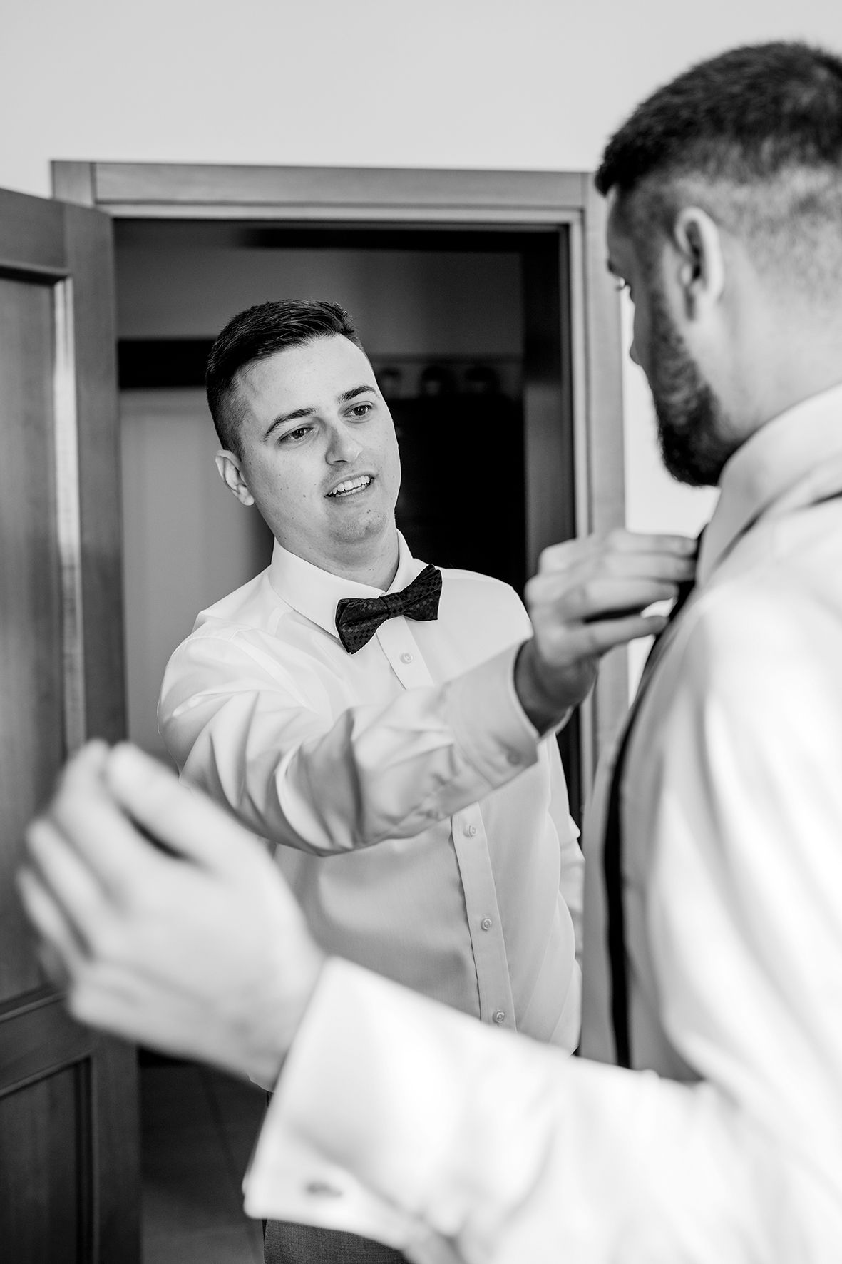 Black and white sequence showing preparations in formal white shirts.