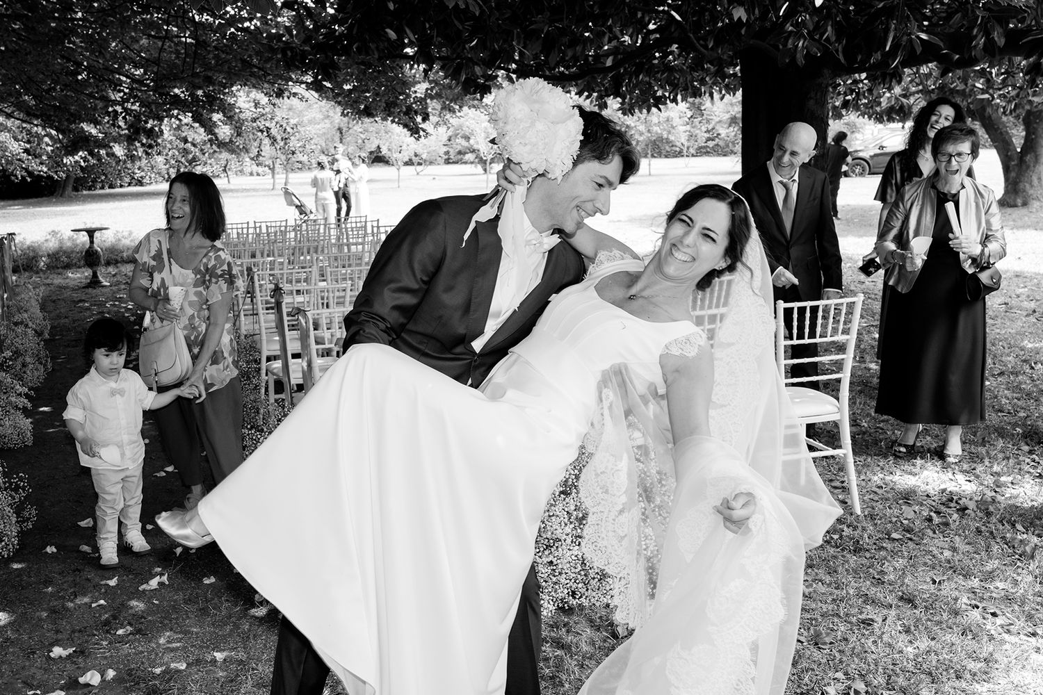 Black and white sequence of wedding ceremony moments under trees.