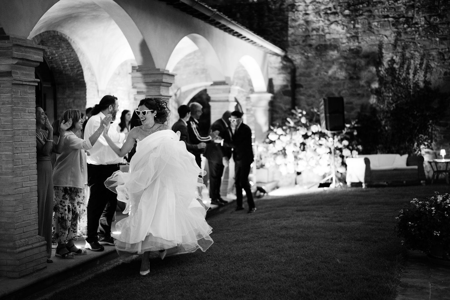 Black and white wedding party photos showing outdoor venue and guests during a celebration.