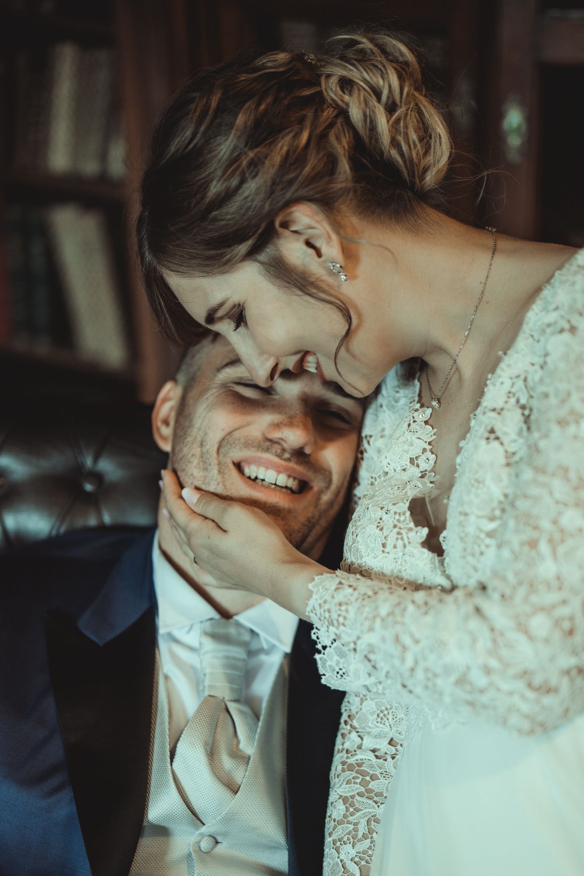 Intimate moment between newlyweds sharing laughter and embrace.