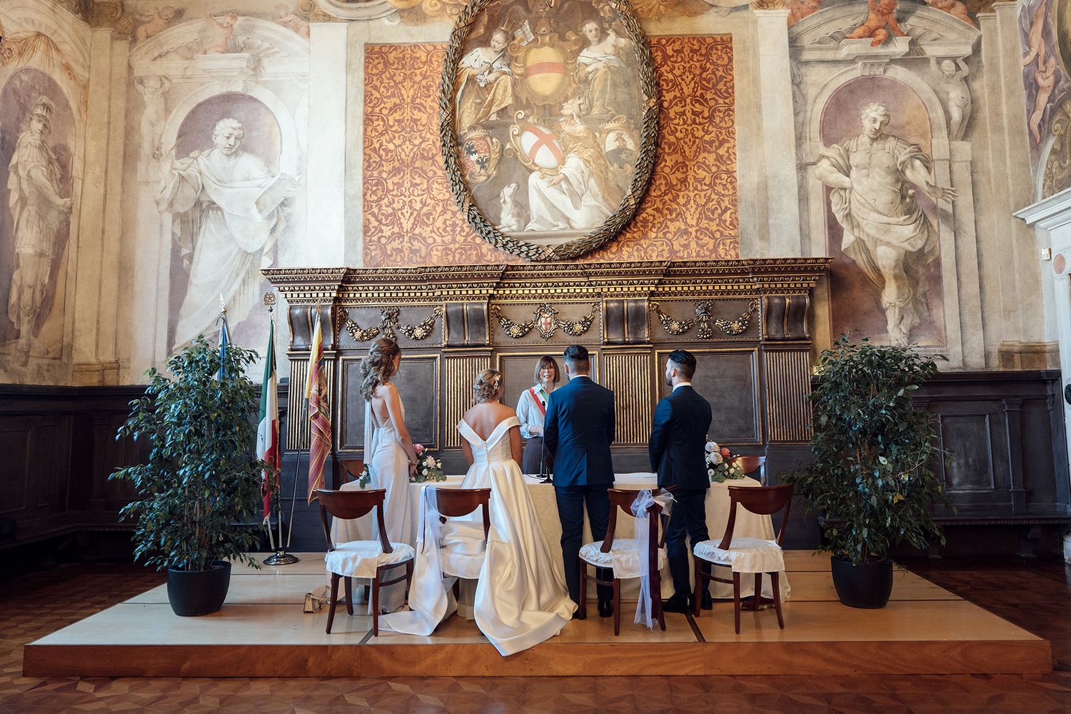 Panoramic view of an ornate wedding venue with decorative walls and high ceilings.