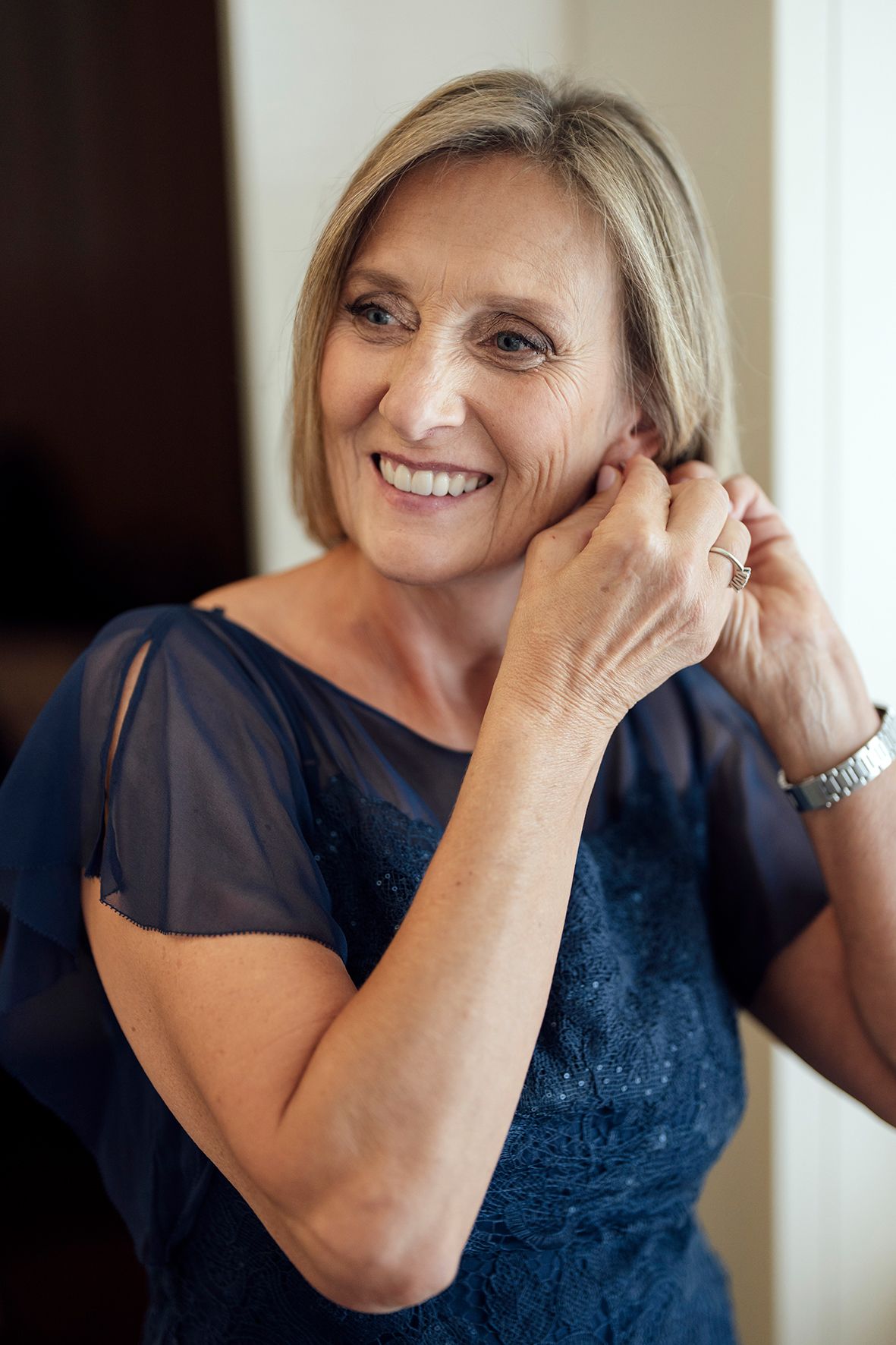 Person in a navy blue dress showing joyful expressions.