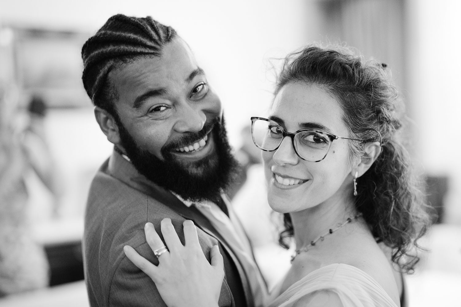 Series of candid black and white photos showing joyful wedding moments.