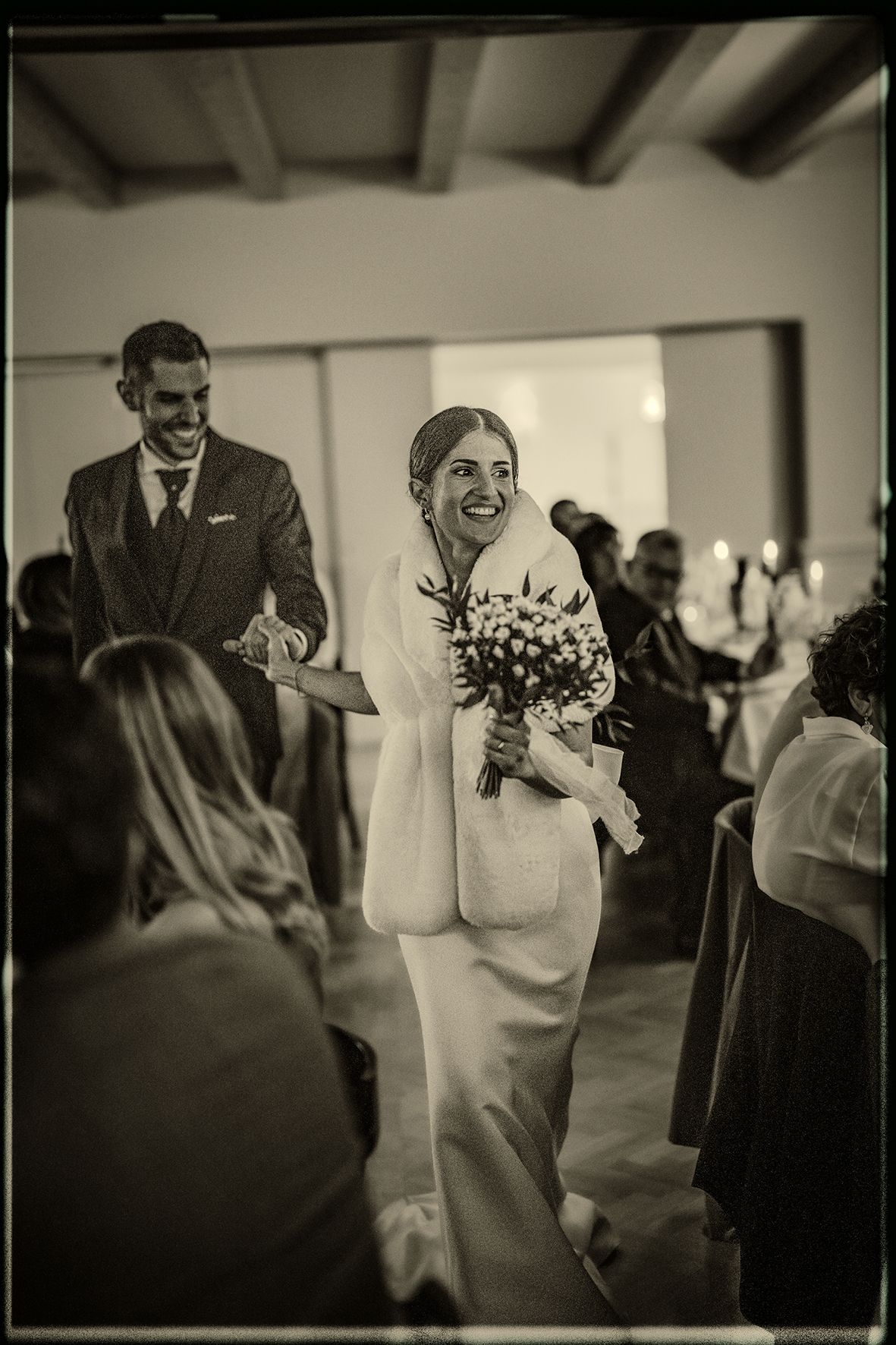 A series of black and white wedding photos showing couples dancing and celebrating at a reception.