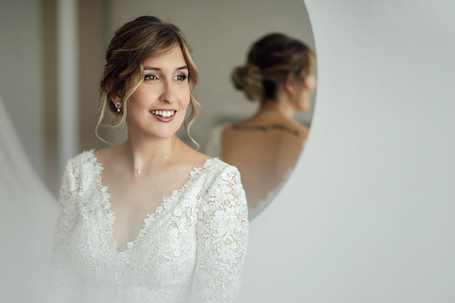 Close-up of bride's joyful expression during wedding preparations.