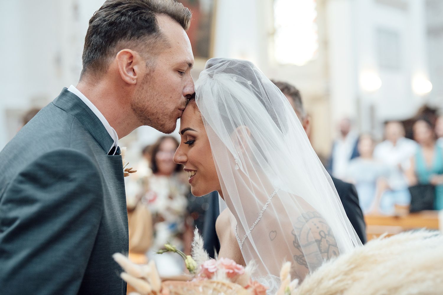 Intimate moment between newlyweds during their church ceremony.