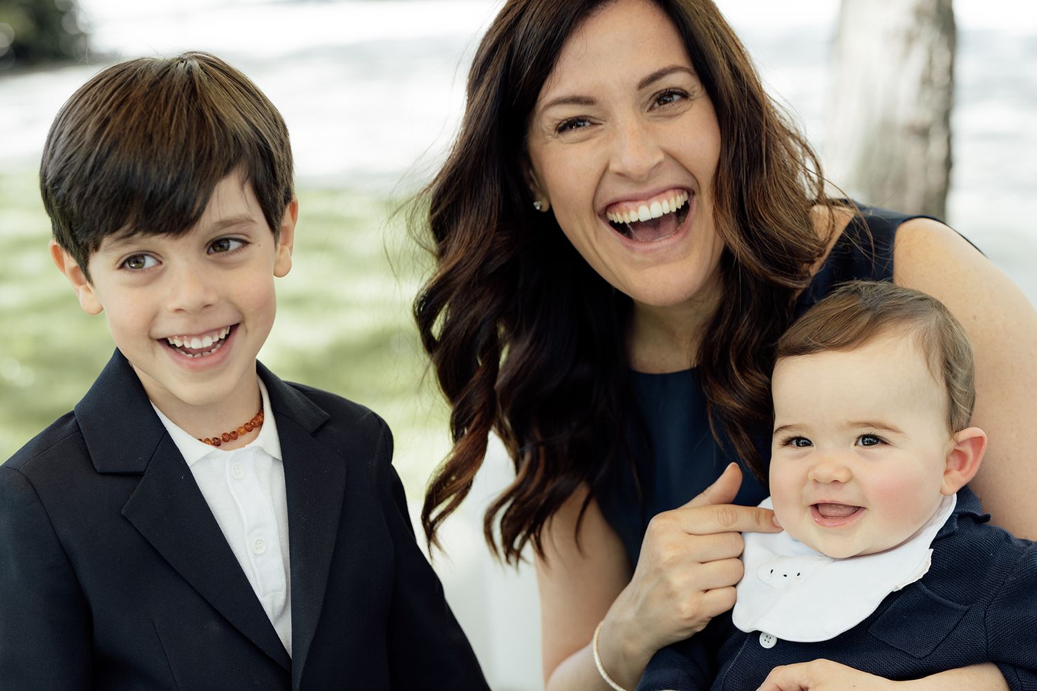 Candid moments of joy shared between wedding party members and a small child.